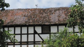 Weathercock on old barn roof in Willingshausen.